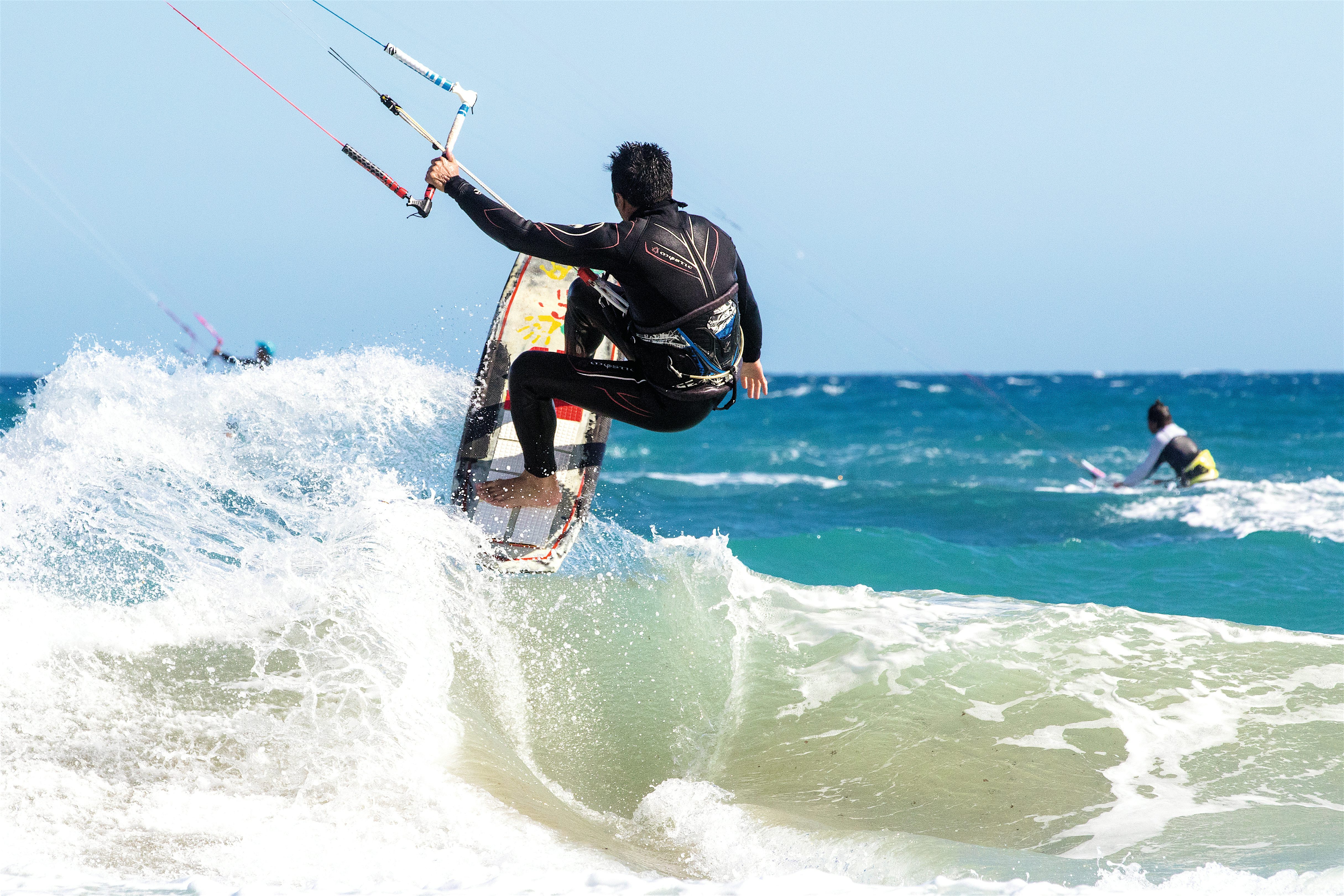 Kitesurfers and large waves