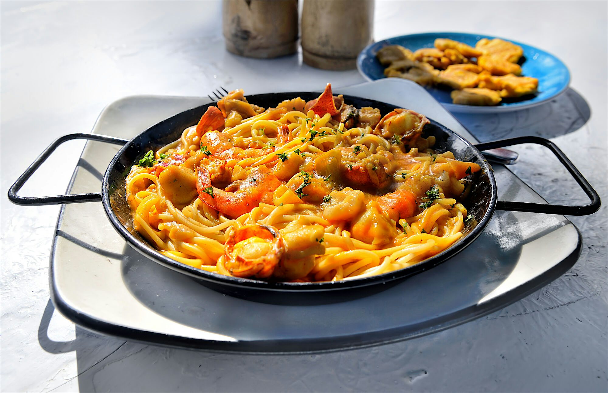 Seafood pasta dish in a shallow cast-iron skillet