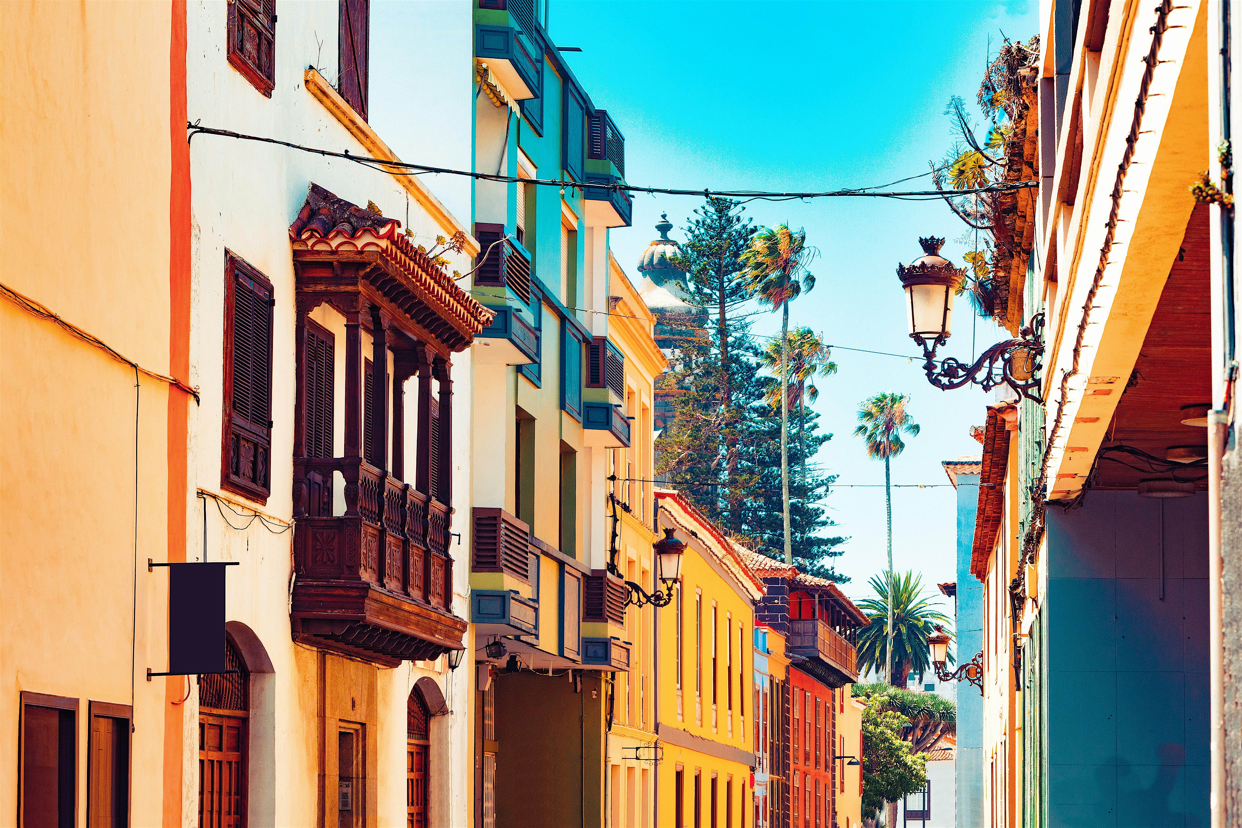 La Laguna Old Town. Historic street of colourful buildings,  one with an ornate wooden balcony