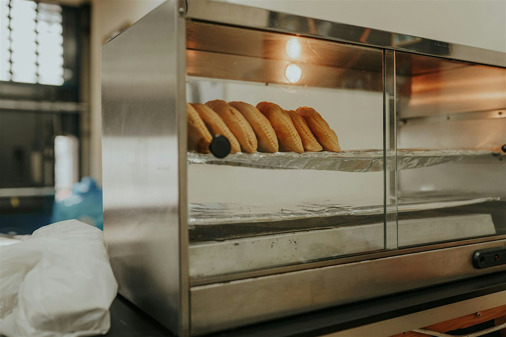 Heated display cabinet with row of Jamaican patties