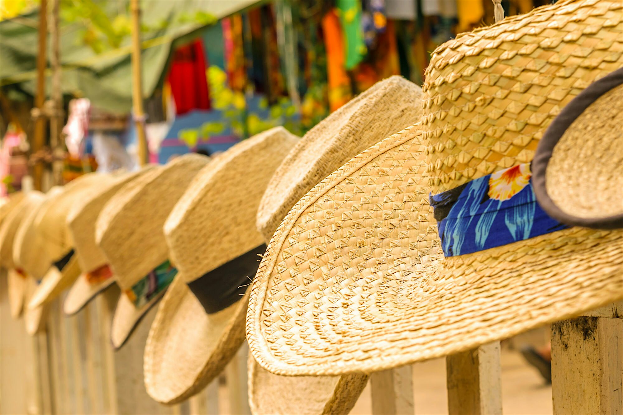 Handmade straw sun hats at a craft market