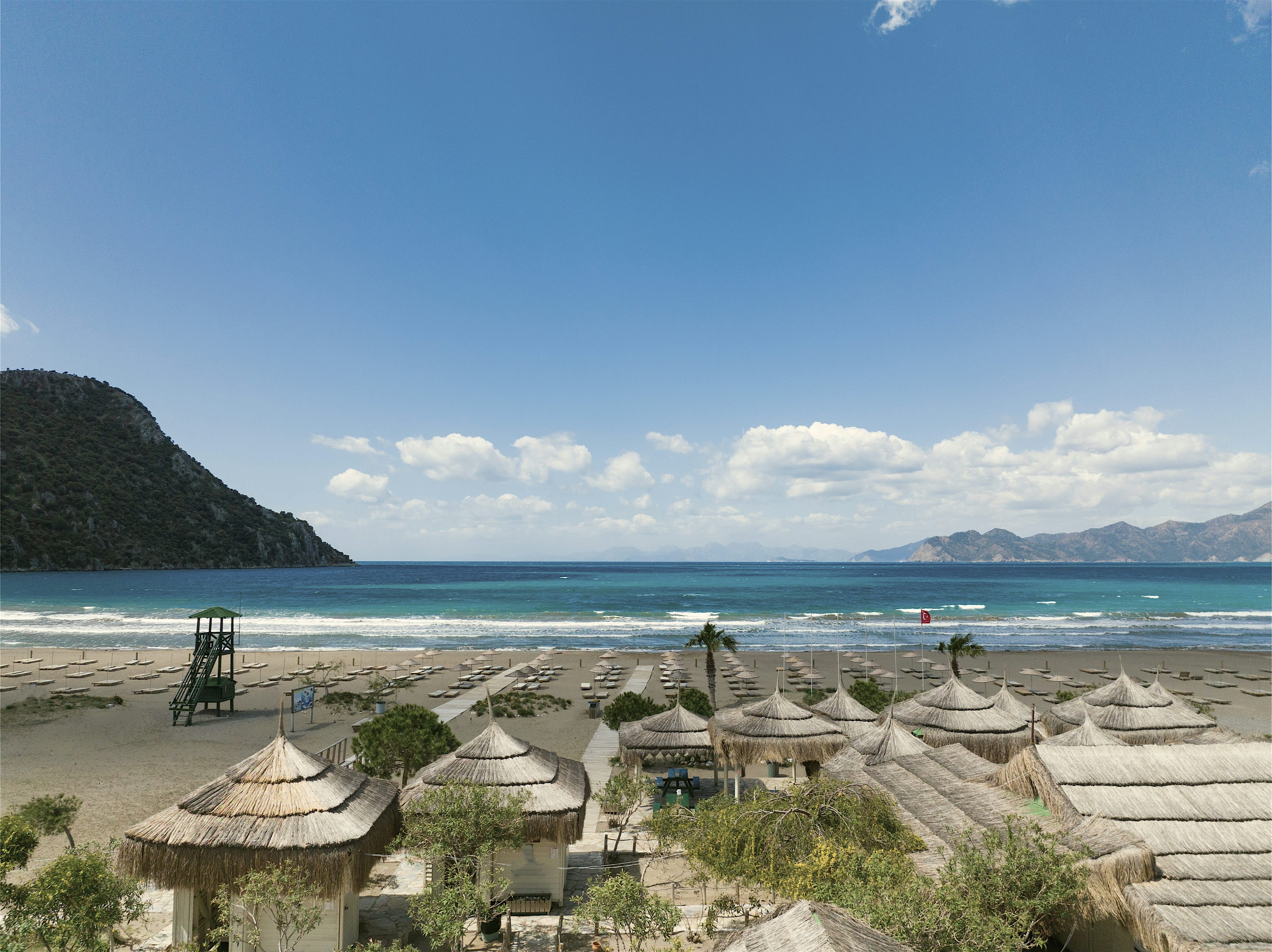 Turtle beach with rustic thatched umbrellas