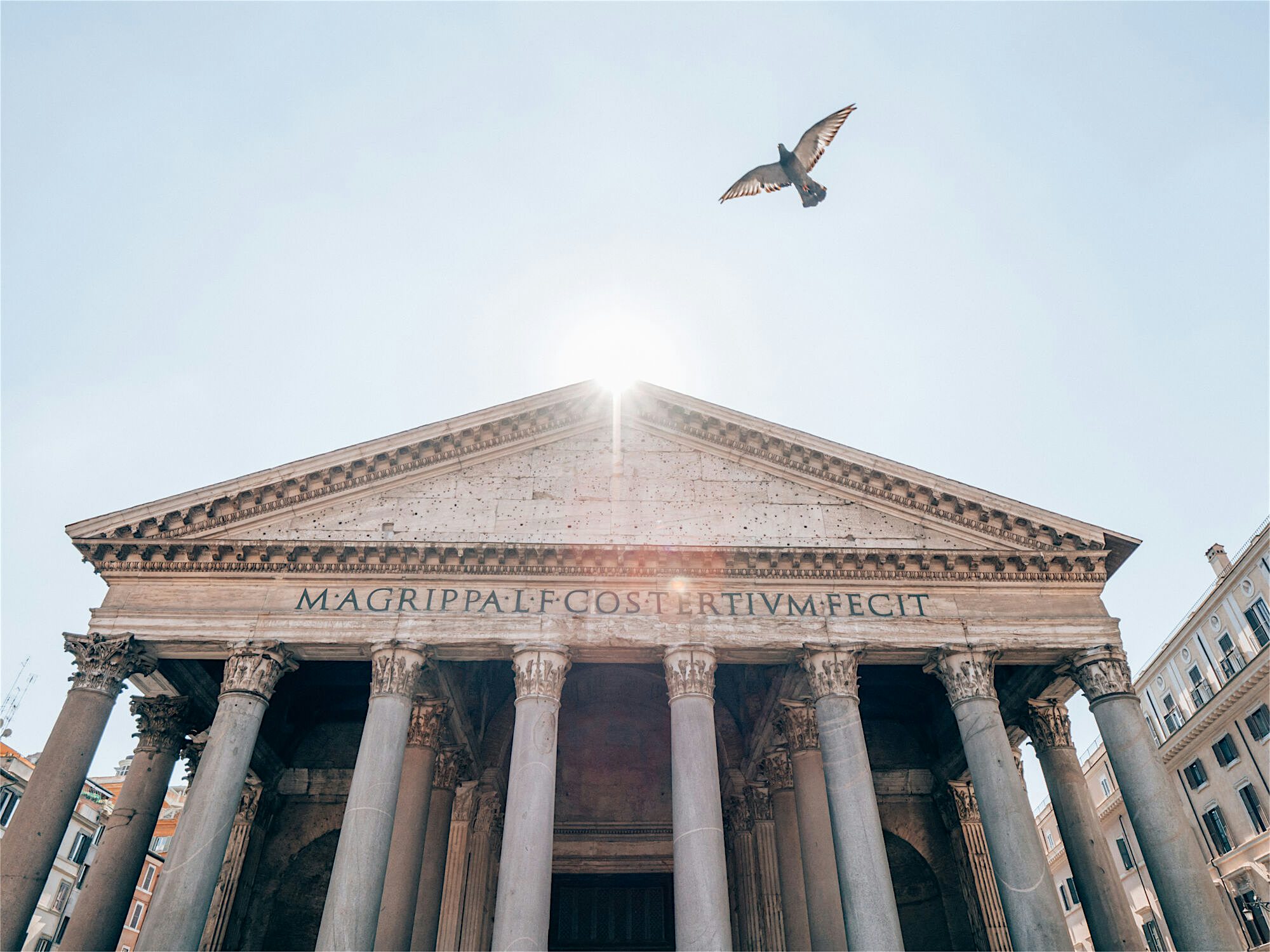 Pantheon temple, which was built 2,000 years ago. A bird is shown flying past above it in the clear blue sky