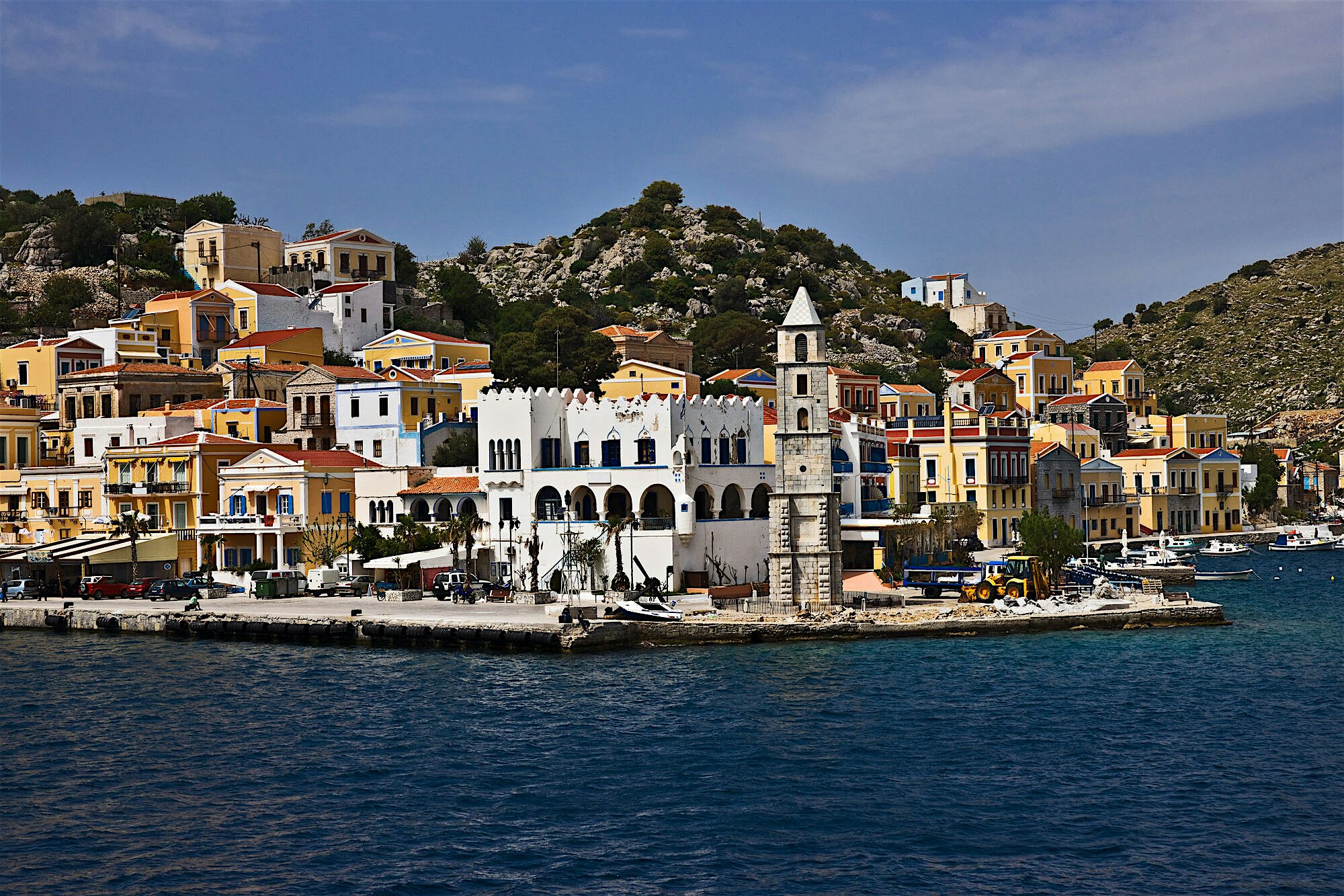 Harbour with colourful Venetian buildings and the Roloi clock tower at the front