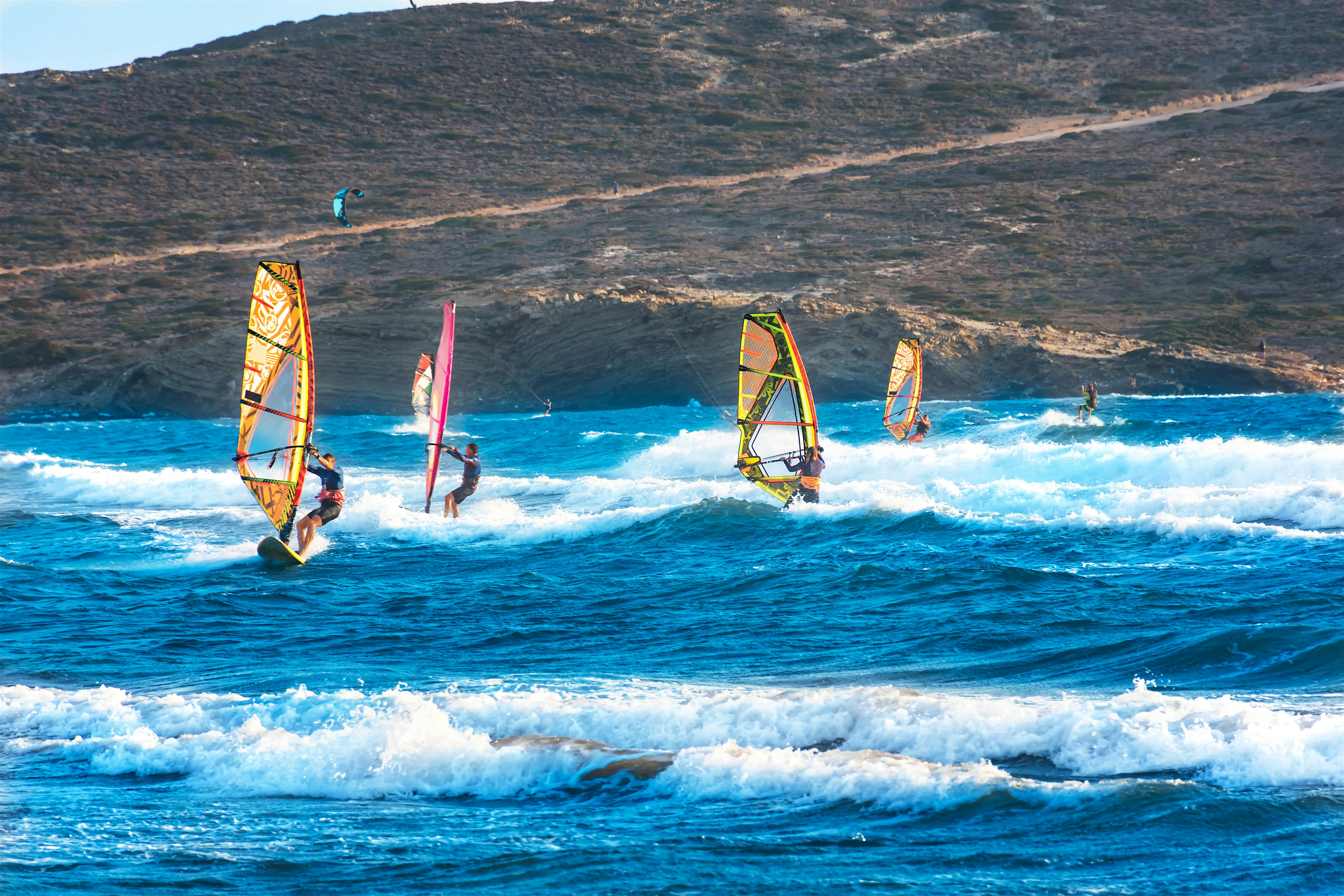 Windsurfers and kitesurfers on the Aegean Sea.