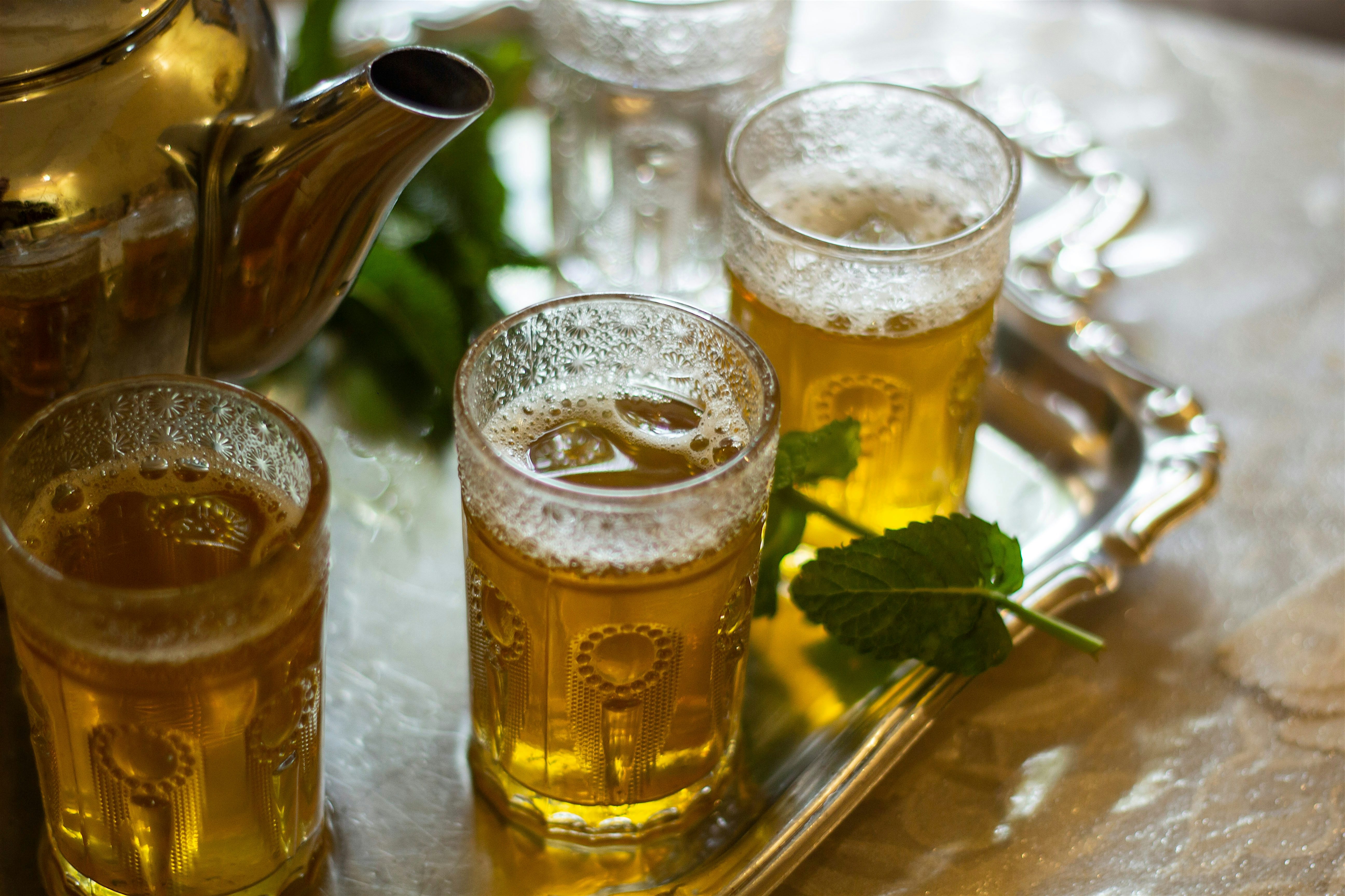 A tray of mint teas and a teapot steeping