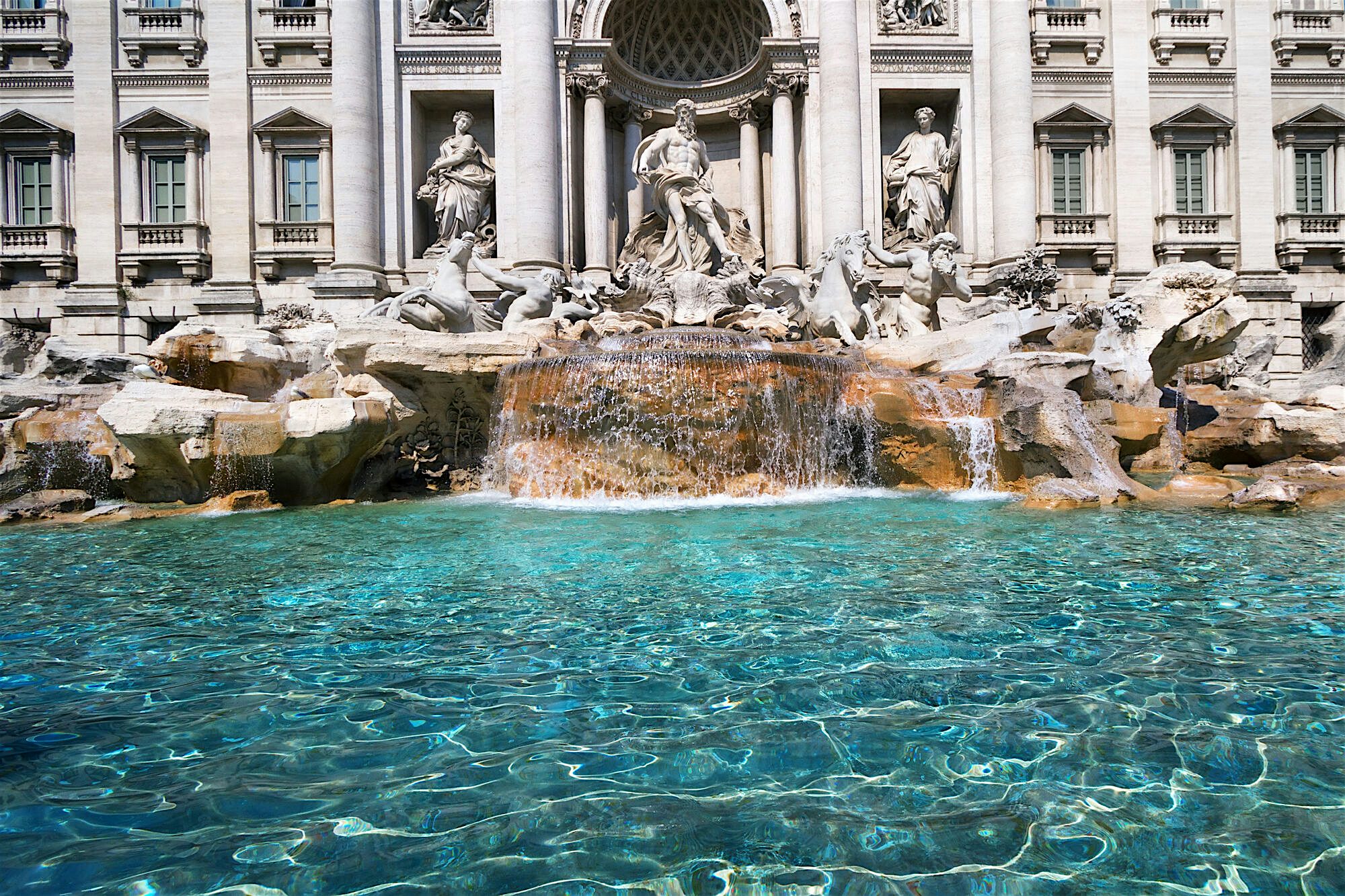 Trevi Fountain, the ornate sculptures and stone work can be seen in the top of the picture and the flowing water in the bottom.