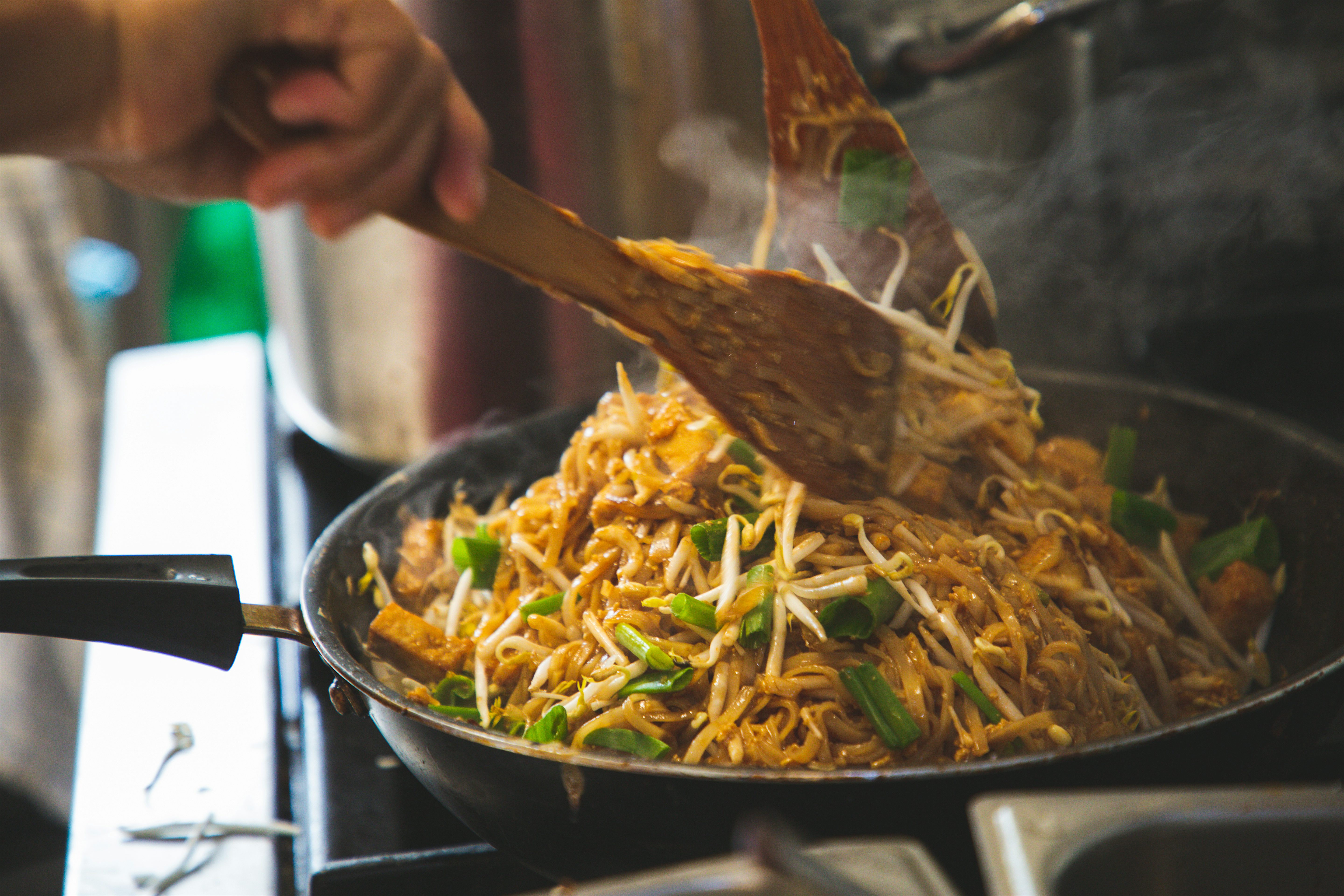 Wok of steaming hot Pad Thai, a popular stir-fried noodle dish