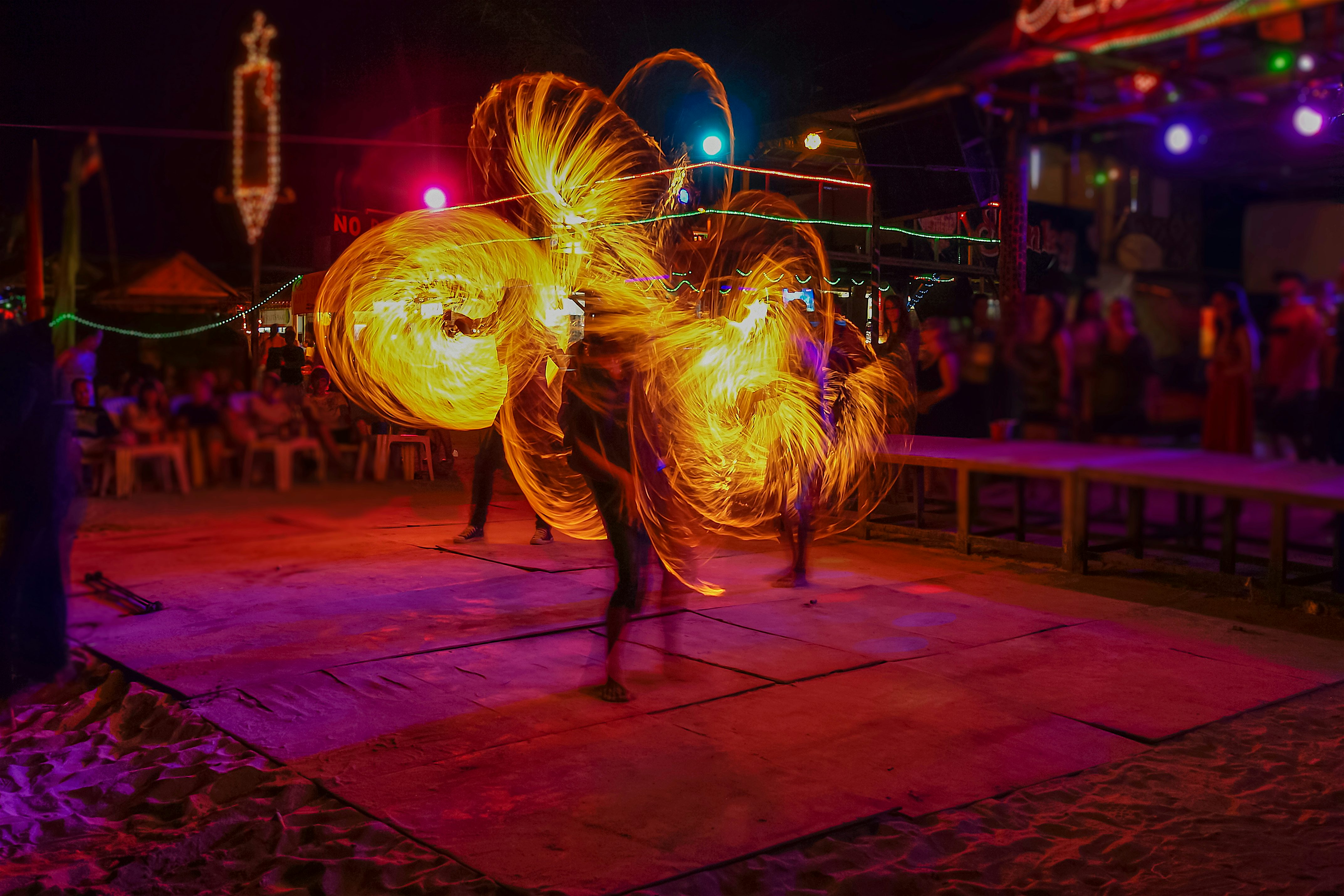 Night time beach party with fire show performers