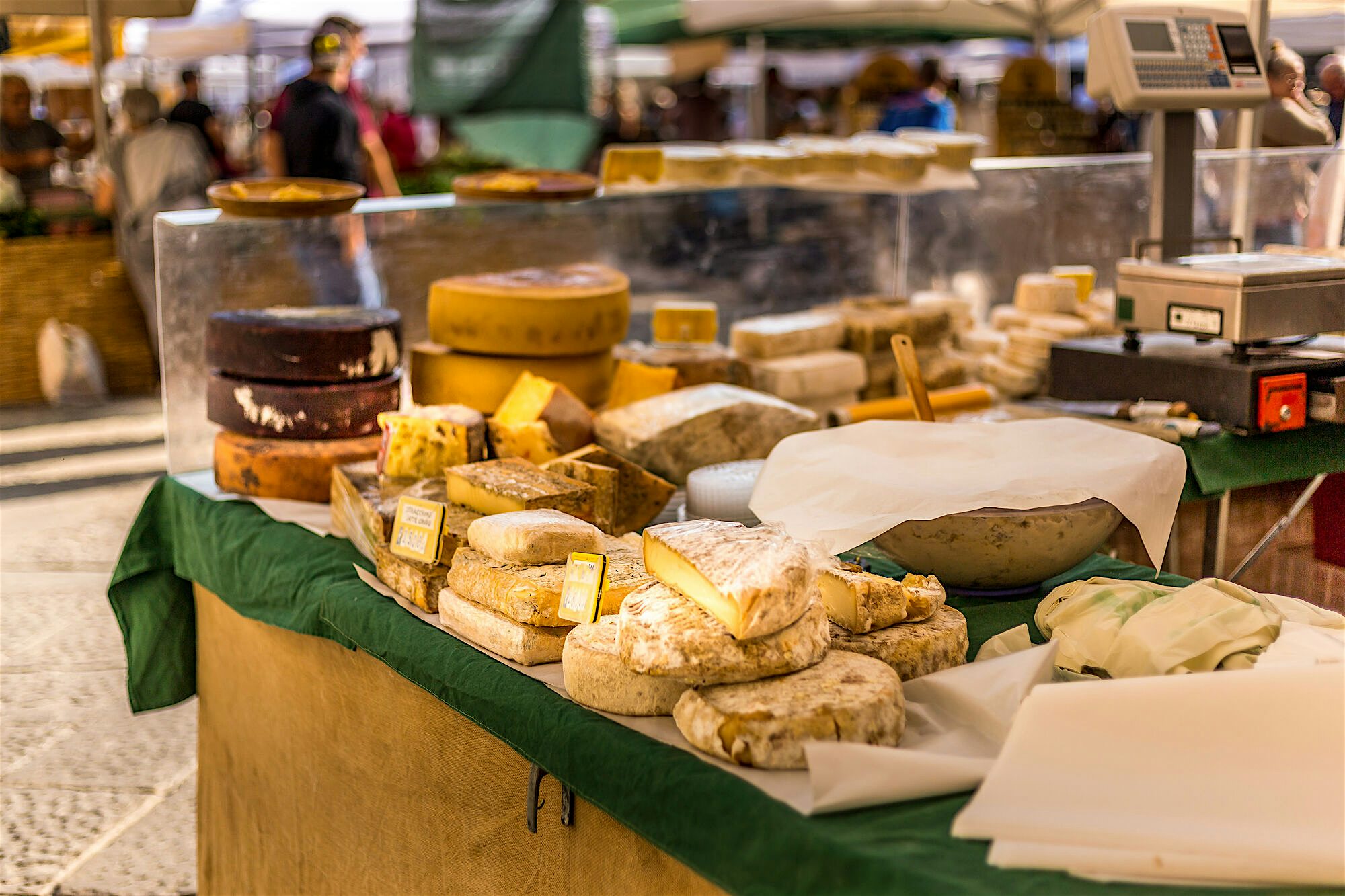 Selection of a local cheese, and fresh produce at a local market