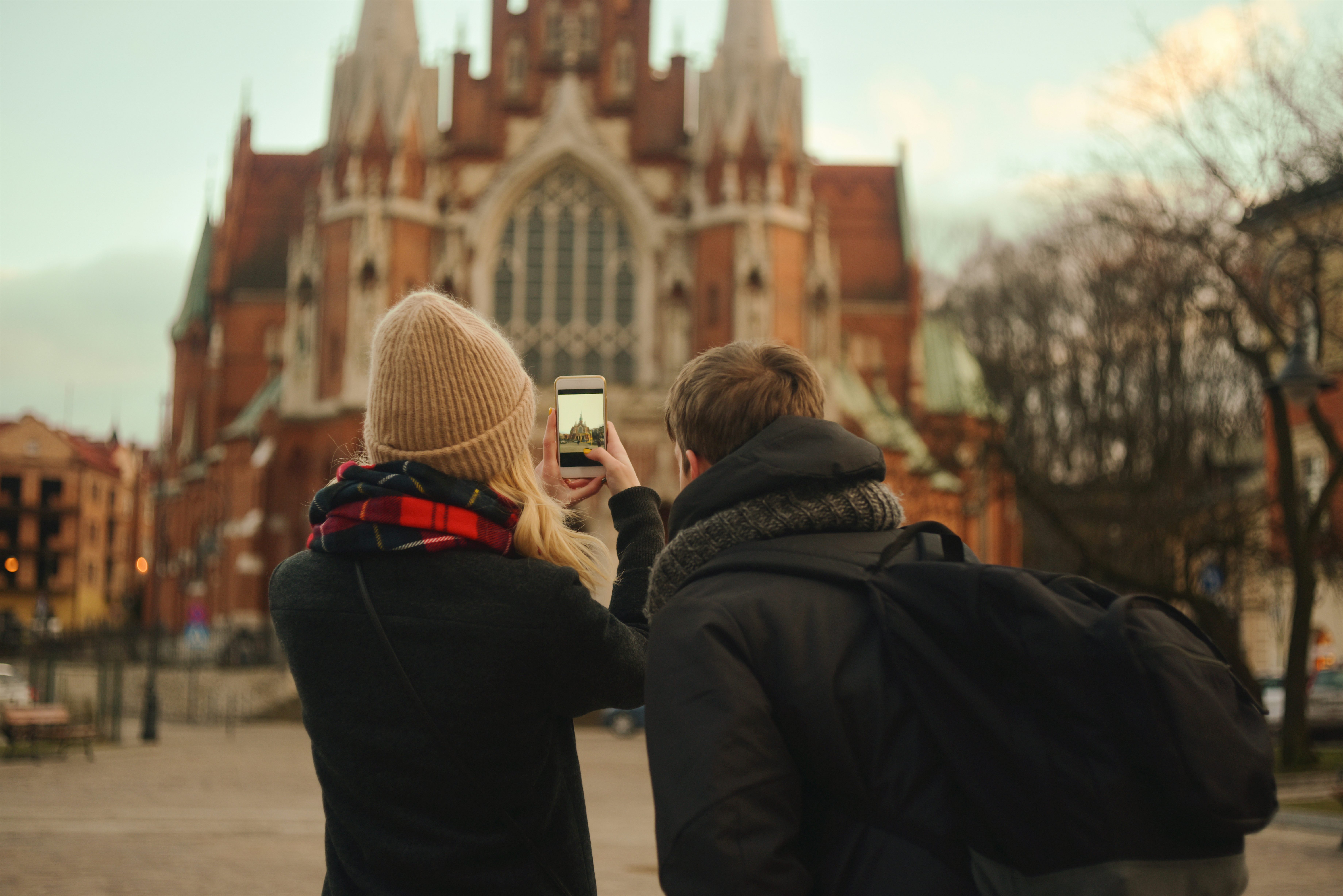 Couple taking a picture of a historic building