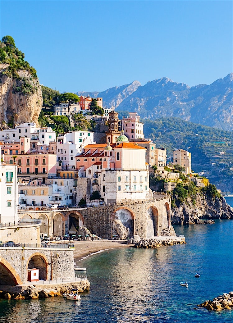 Amalfi Coast Italy with colourful cliffside village, dramatic mountains, Mediterranean Sea and historic coastal architecture.