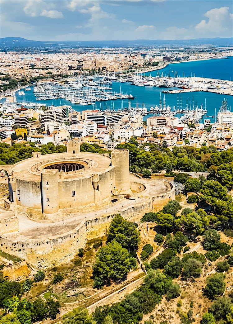 Bellver Castle overlooking Palma de Majorca, with panoramic views of the city, marina and Mediterranean coastline.