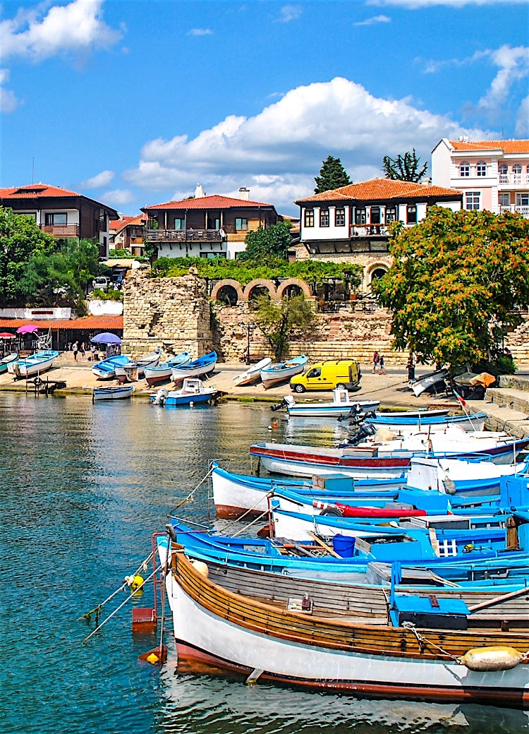 Nessebar, Bulgaria, historic waterfront with fishing boats, traditional architecture, ancient stone ruins, and scenic Black Sea harbour views.