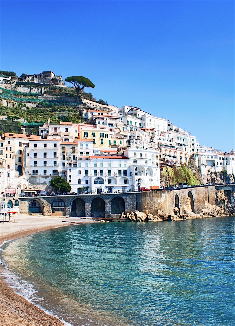 Amalfi Coast historic church overlooking rugged mountains, coastal village architecture and panoramic Italian seaside scenery.