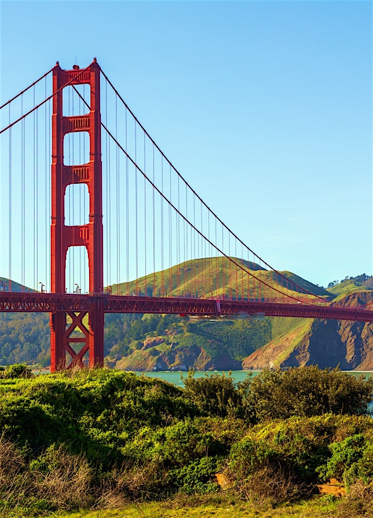 Golden Gate Bridge in San Francisco, California, spanning San Francisco Bay with iconic red suspension towers and scenic coastal hills.