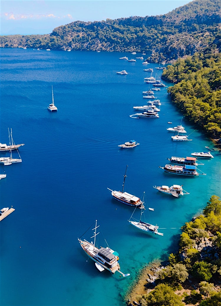 Dalaman coast, Turkey, with turquoise bays, luxury yachts, forested hills, and scenic Mediterranean shoreline views.