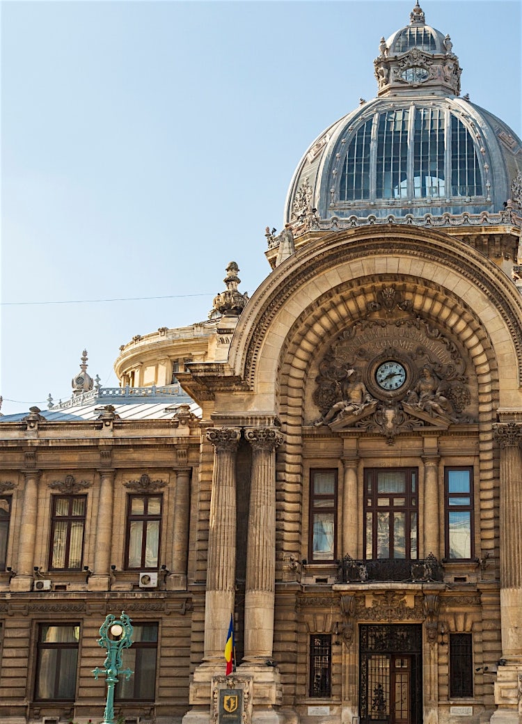 Romanian Athenaeum, Bucharest, featuring a grand neoclassical facade, ornate dome, and historic architectural details.
