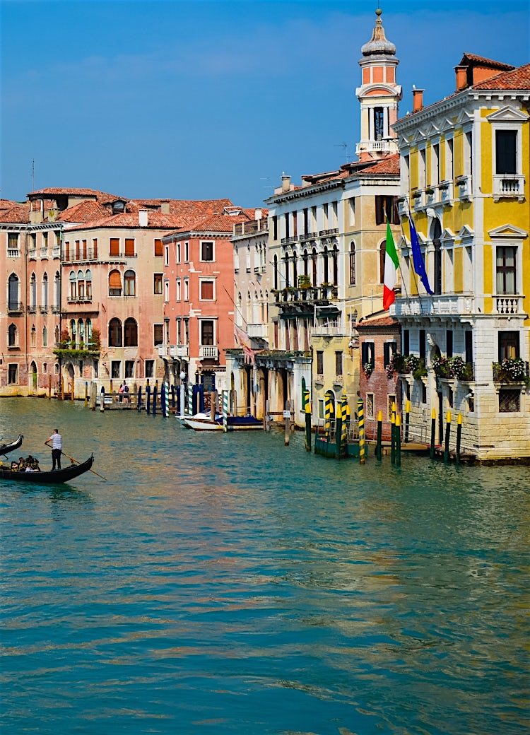 Grand Canal in Venice, Italy, lined with historic Venetian palaces, colourful waterfront buildings and traditional gondolas on the water.