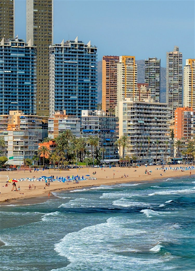 Benidorm beachfront skyline with high-rise hotels, sandy beach and Mediterranean coast, Spain.