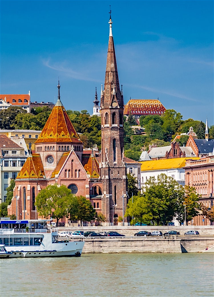 Budapest, Hungary riverside skyline featuring Matthias Church, historic architecture, Danube waterfront buildings and the Buda Castle district.