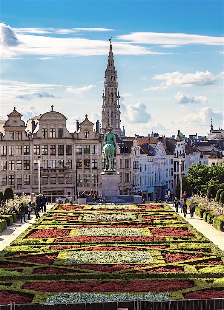 Mont des Arts garden and King Albert I statue overlooking Brussels skyline, featuring historic architecture