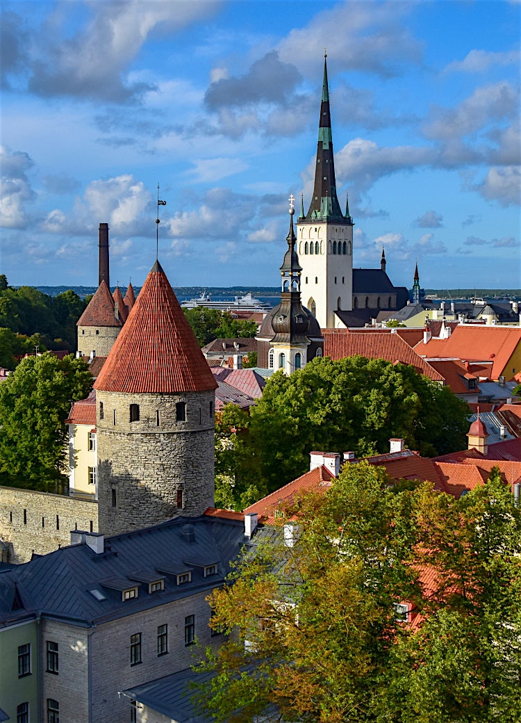 Tallinn Old Town skyline with medieval towers, red-roofed buildings, St. Olaf’s Church, and historic city walls overlooking Estonia’s capital.