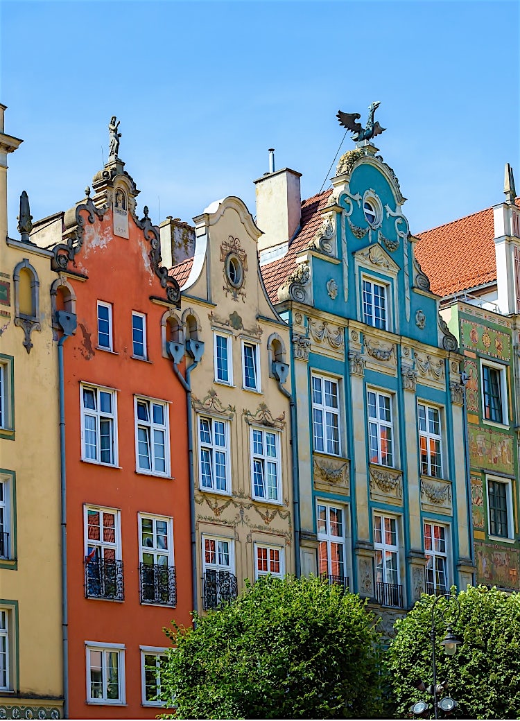 Colourful historic merchant houses in Poznań Old Market Square, Poland, featuring ornate Renaissance facades and traditional architecture.