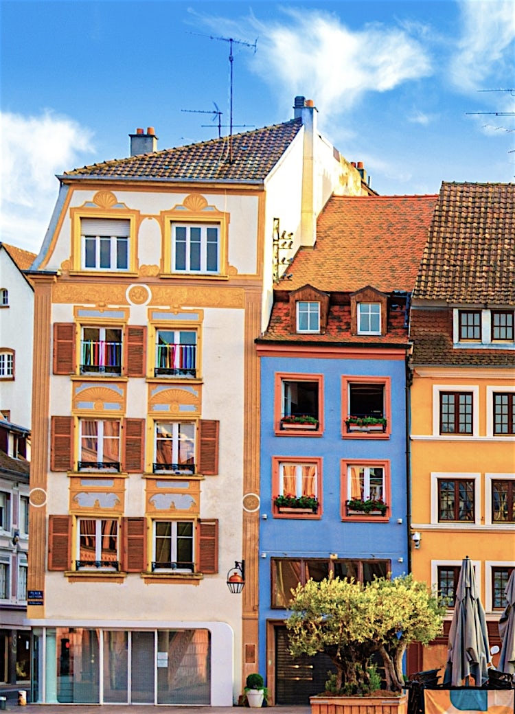 Colmar Old Town, France, with colorful half-timbered buildings, historic architecture, and a lively Alsatian town square.
