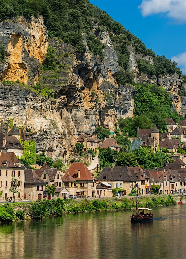 La Roque-Gageac, Dordogne, France, with riverside stone houses, dramatic limestone cliffs, and traditional village architecture.
