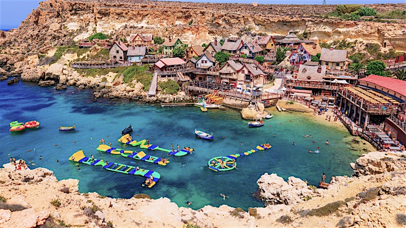 Mellieha Bay Malta coastal cove with turquoise waters, waterfront attractions and rocky coastline