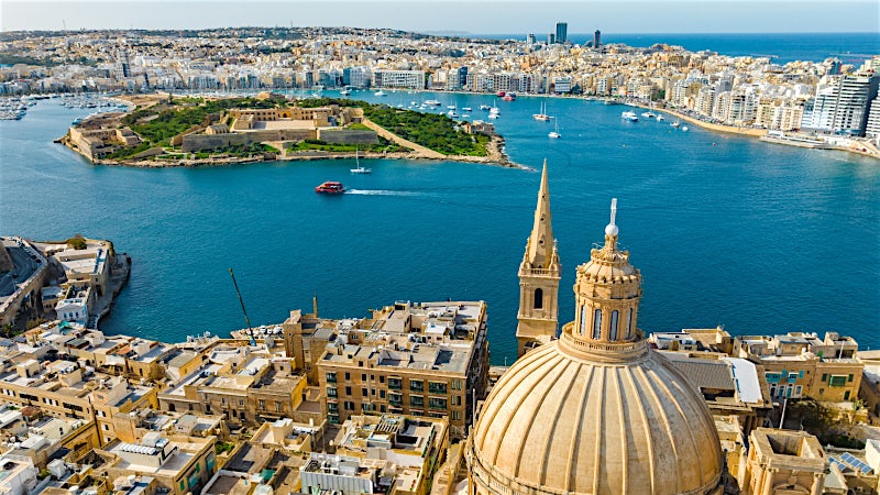 Valletta Malta harbour view with historic city skyline, waterfront fortifications and Grand Harbour