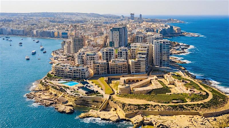 Sliema Malta waterfront skyline with historic fort, modern cityscape and Mediterranean coast