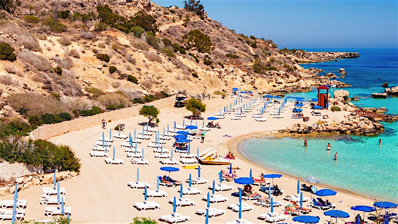 Nissi Beach with golden sand, turquoise water and sun loungers, Ayia Napa, Cyprus.