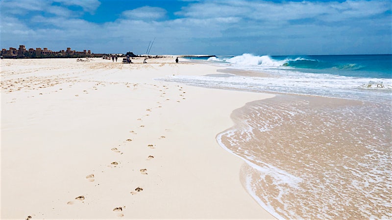 Pristine white sand beach with Atlantic waves and turquoise ocean, Boa Vista, Cape Verde.