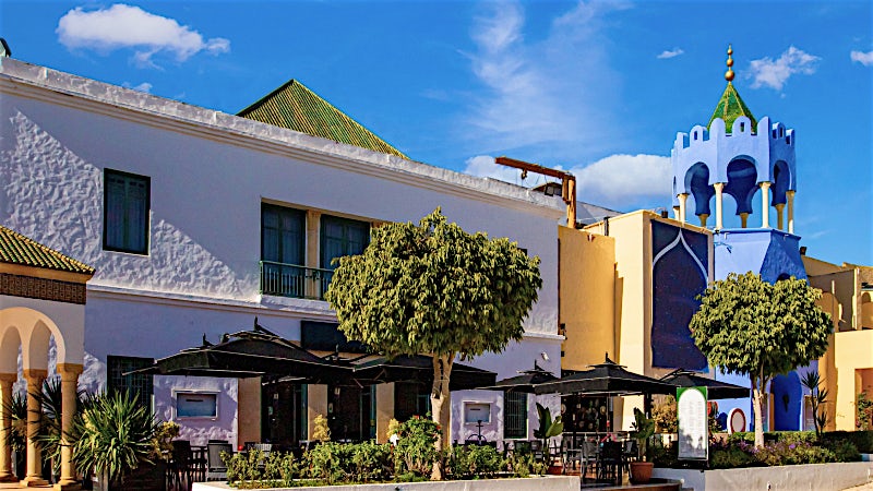 Yasmine Hammamet marina district with Moorish architecture and palm trees, Tunisia.