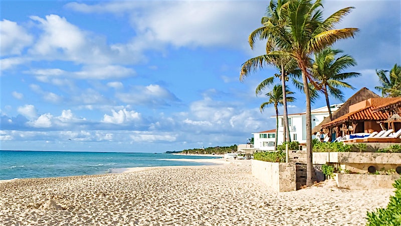 Palm-lined Caribbean beach with white sand and turquoise sea, Playacar, Riviera Maya, Mexico.