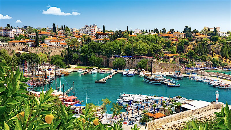 Antalya Turkey marina with yachts, turquoise harbour and historic waterfront city skyline