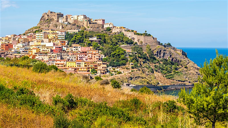 Sardinia Italy hilltop town with historic castle, coastal landscape and Mediterranean views