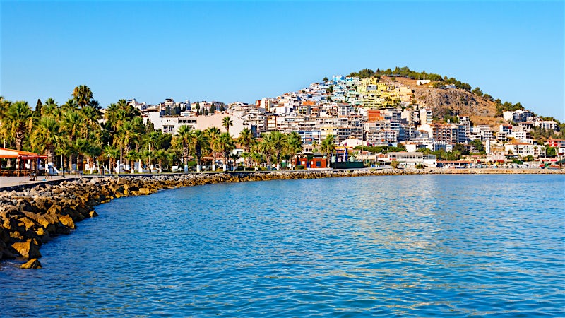 Kusadasi Turkey waterfront with palm-lined promenade, harbour and hillside coastal town views