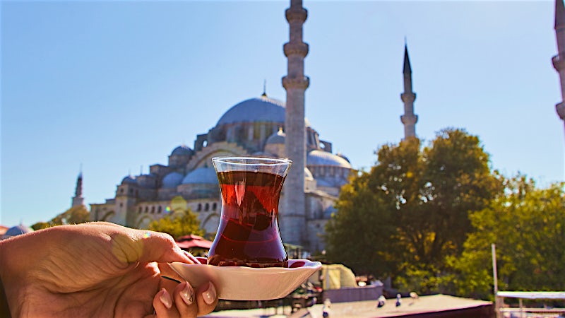 Istanbul Turkey traditional tea glass with Blue Mosque and historic city skyline in background