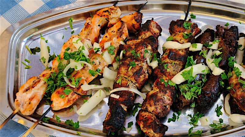 Mixed grilled souvlaki skewers with onions and herbs, traditional Cypriot cuisine.