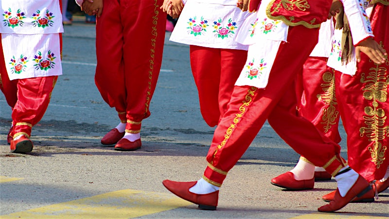 Traditional Cypriot folk dancers in embroidered costumes performing cultural dance, Cyprus.