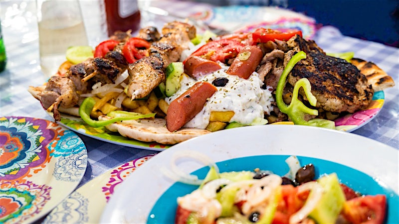 Classic Greek mixed grill platter with souvlaki, gyros, pita and fresh salad.