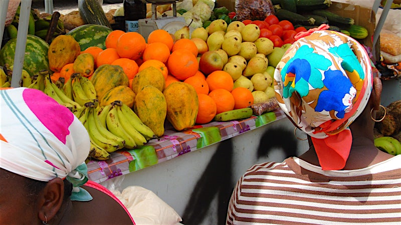 Fresh tropical fruit market stall in Cape Verde with papaya, bananas, oranges and local produce.