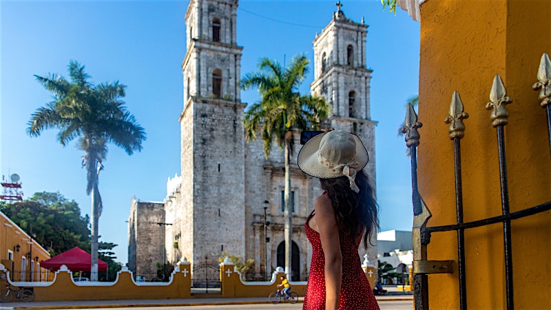 Historic colonial cathedral and palm-lined square in Valladolid, Yucatán, Mexico.
