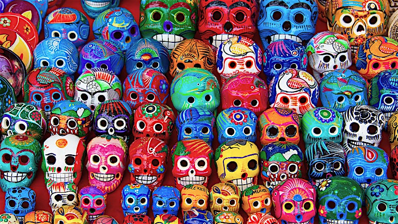 Colourful Mexican Day of the Dead skulls and handcrafted traditional folk art souvenirs.