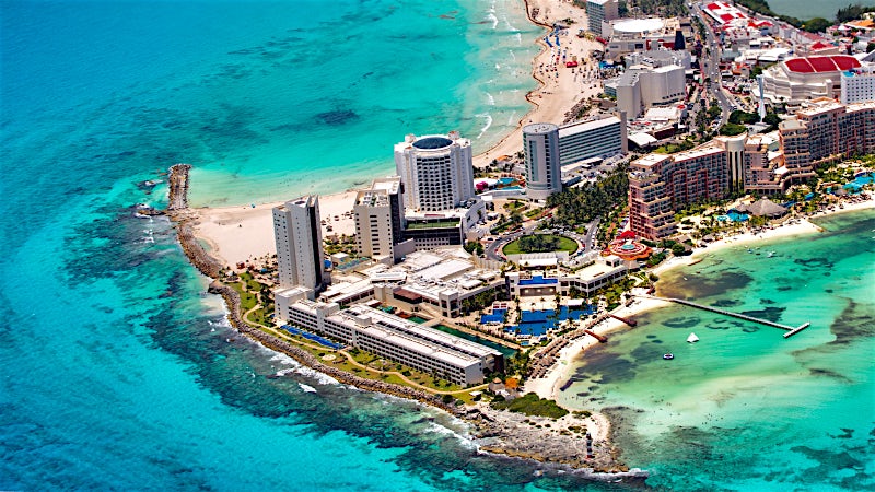Aerial view of Cancun Hotel Zone with luxury resorts, white sand beaches and turquoise Caribbean Sea, Mexico.