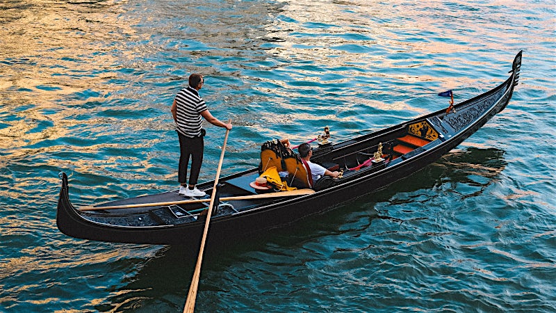 Traditional gondola ride on Grand Canal waterways, Venice, Italy.