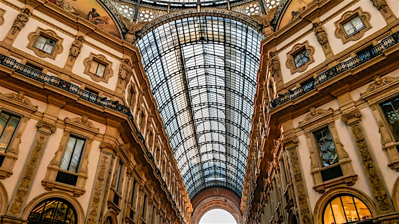 Galleria Vittorio Emanuele II glass-vaulted shopping arcade and historic architecture, Milan, Italy.